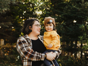 mother standing proudly with her child after her surrogacy experience (MODELS)