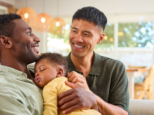 Same-sex male couple holding their newborn baby at home. Source: Getty Images. Credit: monkeybusinessimages