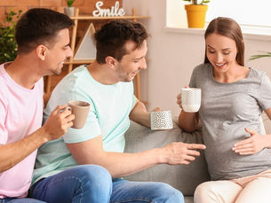 Three people sitting on a couch with a cup of coffee (models)
