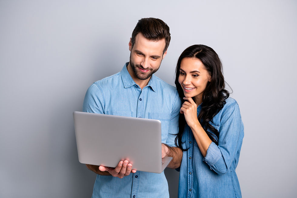 man and woman looking at laptop