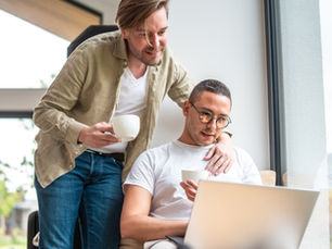 Two men looking at a laptop together (models)