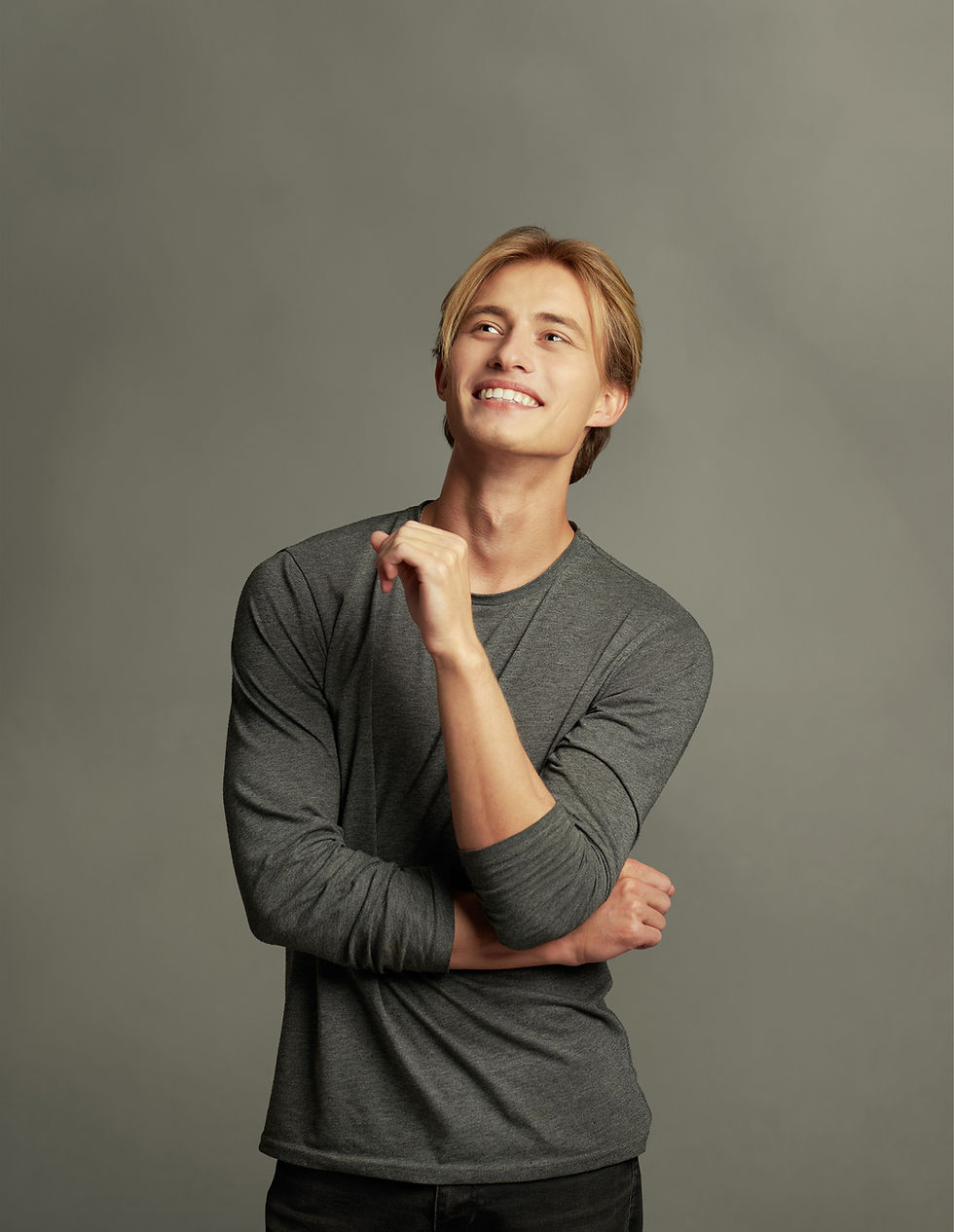 Man looking into the distance with sleeves pushed up