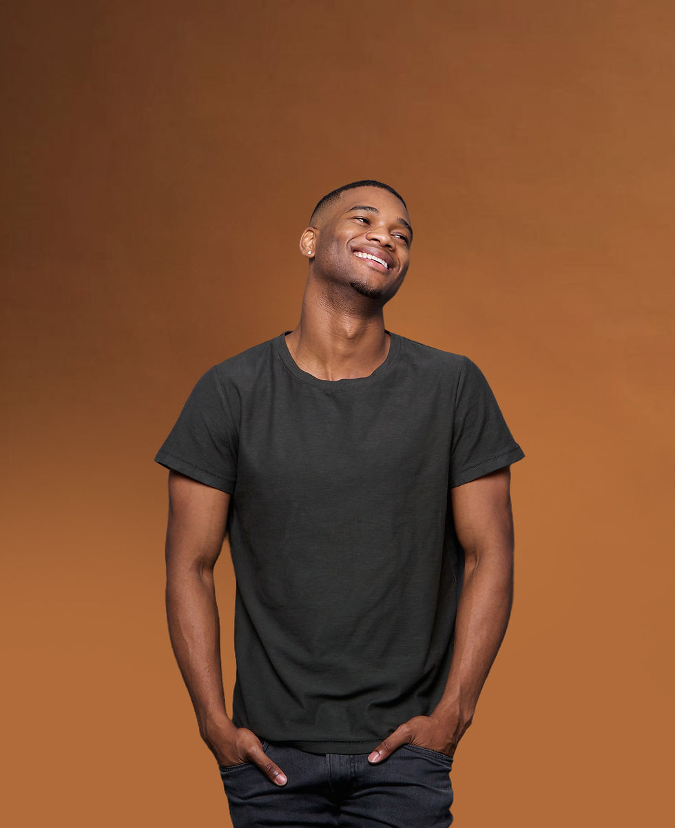 Man wearing a t-shirt smiling off to the right