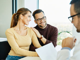 Young couple in a Denver fertility office talking with a doctor during a consultation. Source: Getty Images. Credit: Paperkites