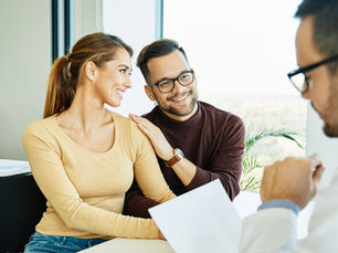 Young couple in a Denver fertility office talking with a doctor during a consultation. Source: Getty Images. Credit: Paperkites